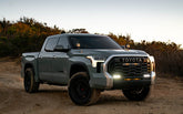 3rd Gen Toyota Tundra with Baja Designs LED light bar, ditch lights, and A-pillar lights illuminated at golden hour