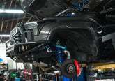 Tru Automotive Tundra in shop with wheel off, ready for suspension install