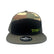Tru Automotive seven panel trucker hat in woodland camo with black front panel and green embroidered TRU logo, front view on white background