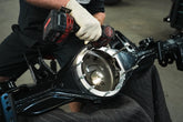 Tru Automotive technician working on a Toyota rear axle housing in the Denver shop