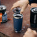 YETI Rambler 20 oz Tumbler with MagSlider Lid lifted at camp