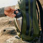YETI Rambler water bottle clipped to a backpack on the trail